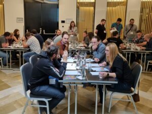 People sat round various tables taking part in a workshop