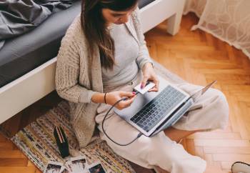 Representation of woman on laptop using ezquant quantum secure finger print technology